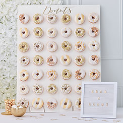 Gold wedding supplies arranged in a styled party setting.