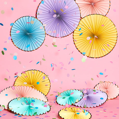 Paper fans arranged in a styled party setting.