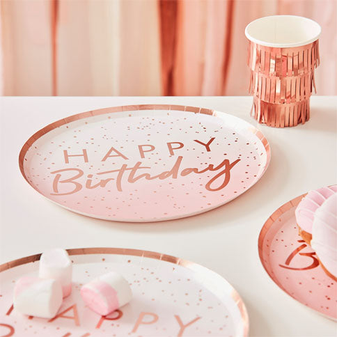 Birthday tableware arranged in a styled party setting.