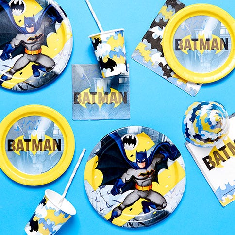 Batman party supplies arranged in a styled party setting.