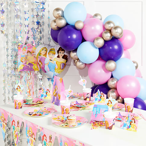 Disney princess party supplies arranged in a styled party setting.