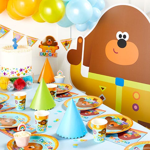 Hey duggee party supplies arranged in a styled party setting.