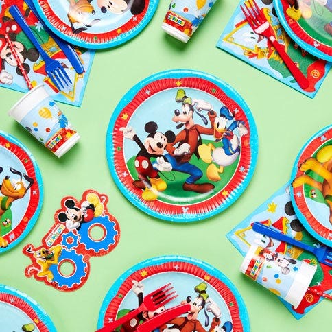 Mickey mouse party supplies arranged in a styled party setting.
