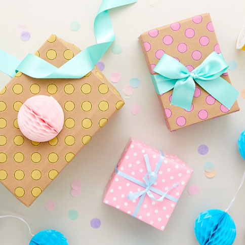 Wrapped gifts with pastel paper, ribbon and thoughtful finishing touches.