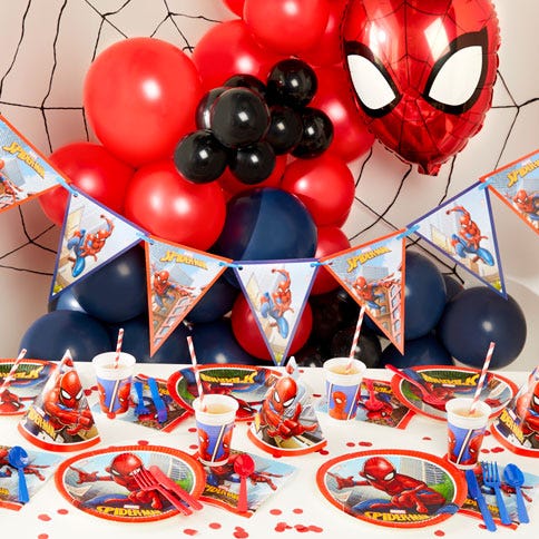 Spider man party supplies arranged in a styled party setting.