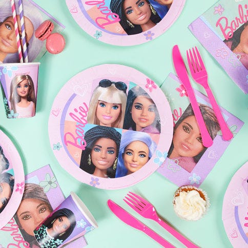 Barbie party supplies arranged in a styled party setting.