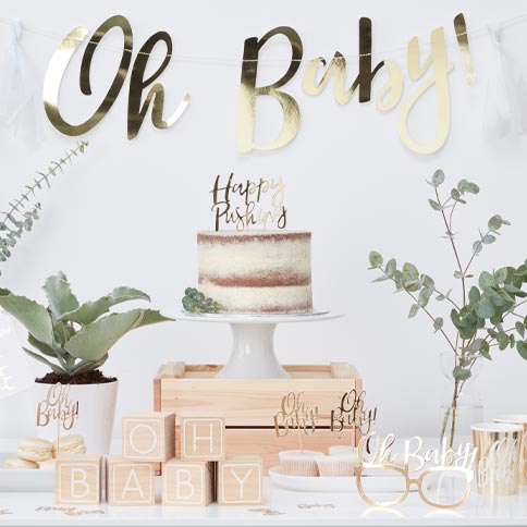 Oh baby party supplies arranged in a styled party setting.