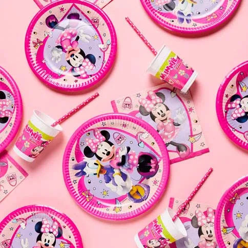 Minnie mouse party supplies arranged in a styled party setting.