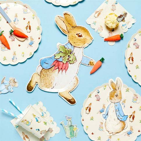 Peter rabbit party supplies arranged in a styled party setting.
