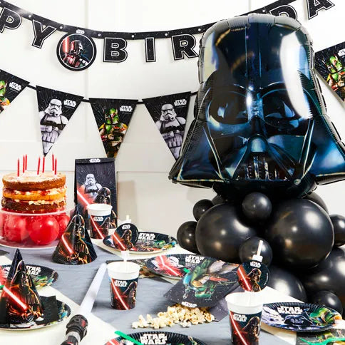 Star wars party supplies arranged in a styled party setting.