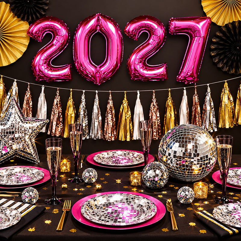 A New Year’s Eve party table with silver disco tableware, gold decorations and metallic pink 2027 balloons.