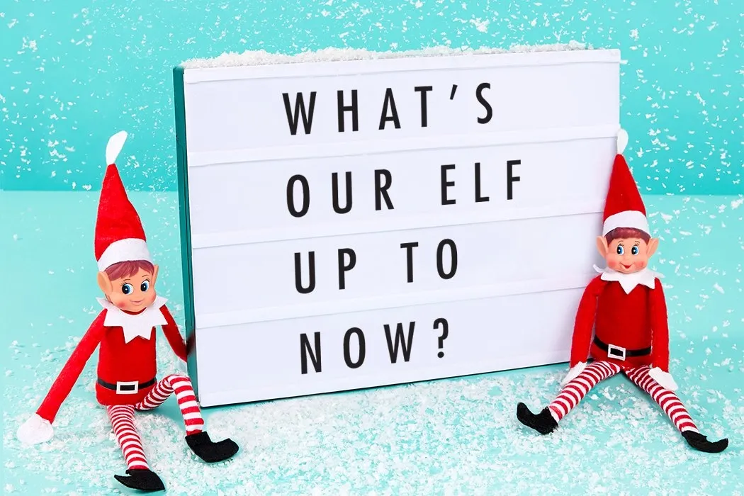 Elf on the shelf sitting in the snow