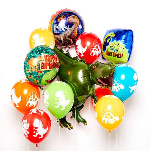 A bouquet of a selection of dinosaur balloons, including colourful latex dinosaur party balloons and a giant green foil T-Rex balloon in the centre.